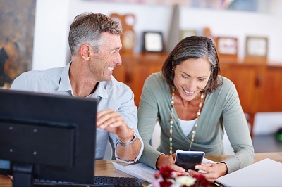 couple looking at a laptop and smartphone