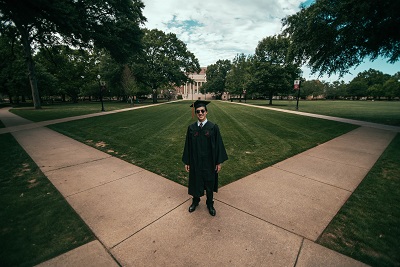 graduate on campus; photo credit Jonathan Daniels via Unsplash