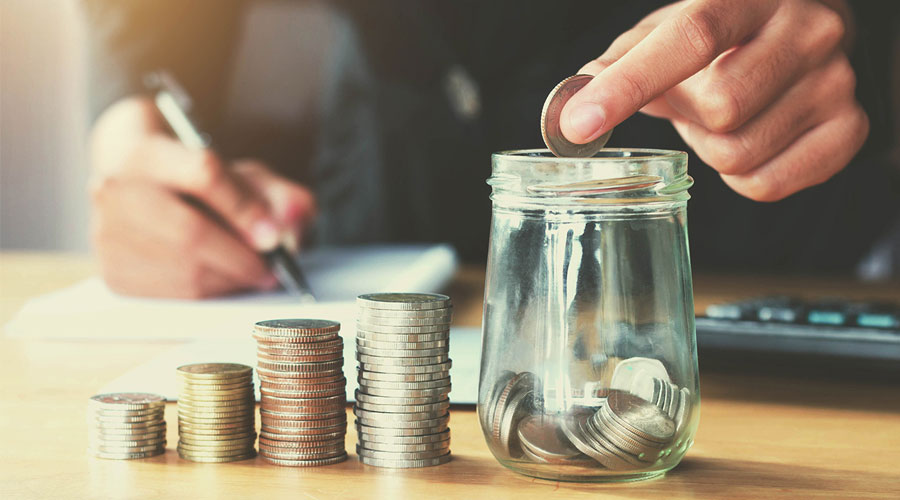 man saving money in jar