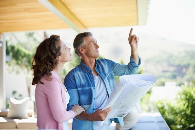 couple looking at remodeling plans